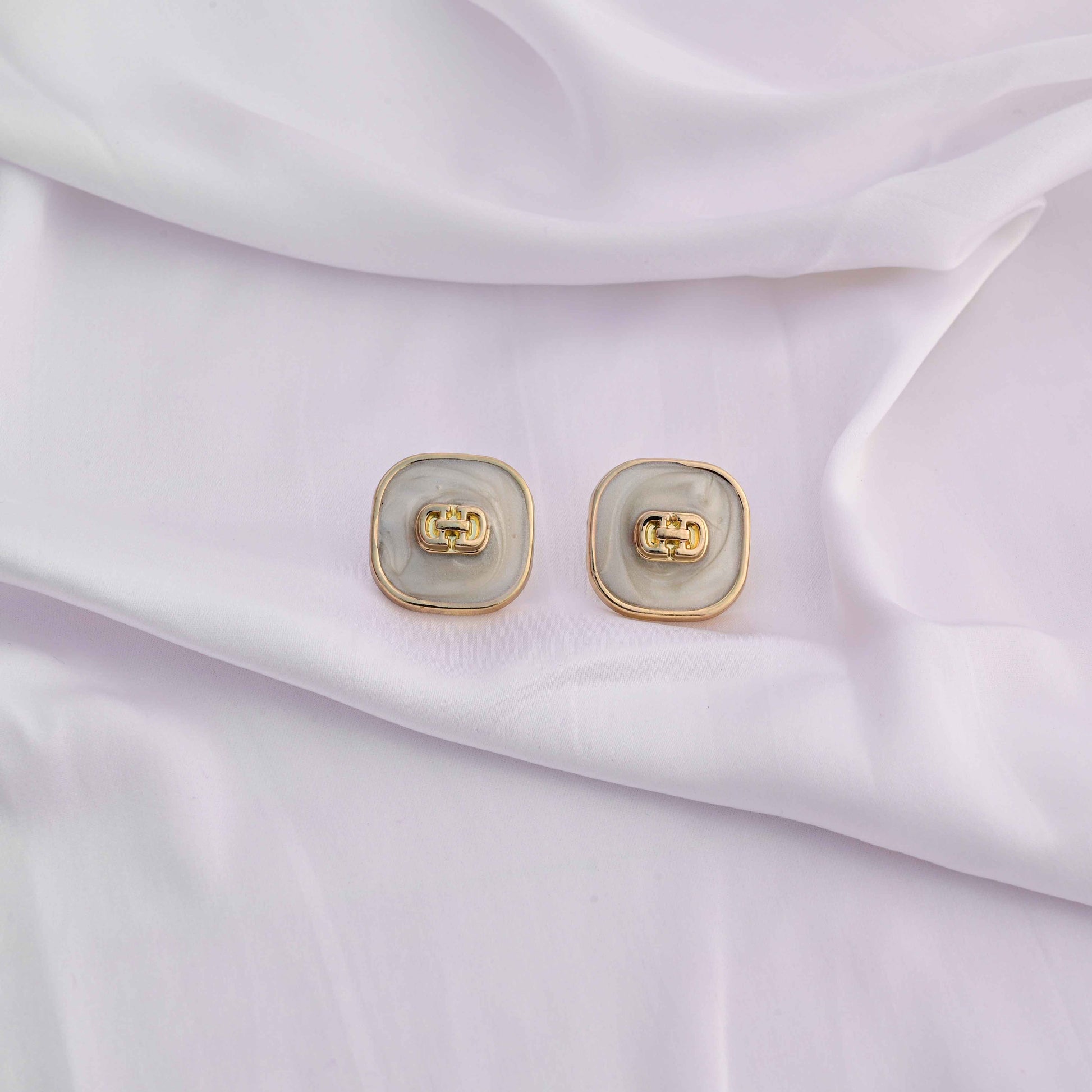 Square gold earrings with ivory enamel