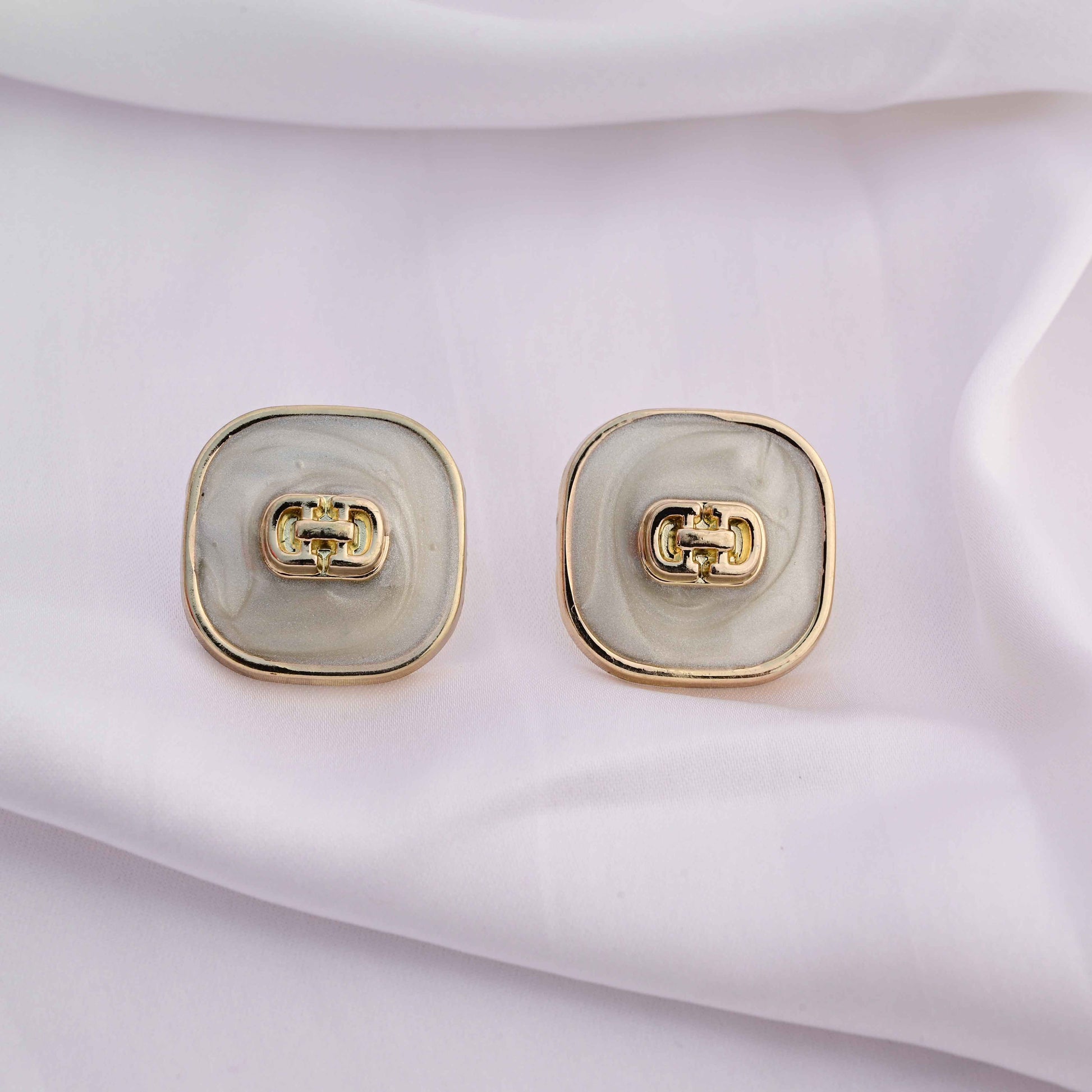 Square gold earrings with ivory enamel