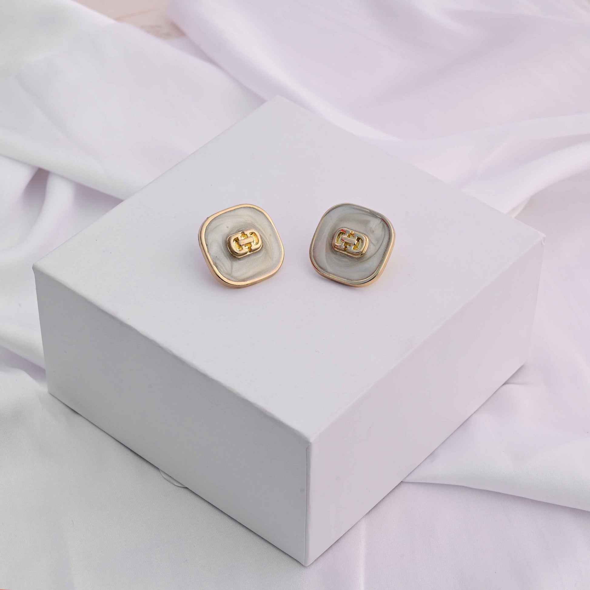 Square gold earrings with ivory enamel