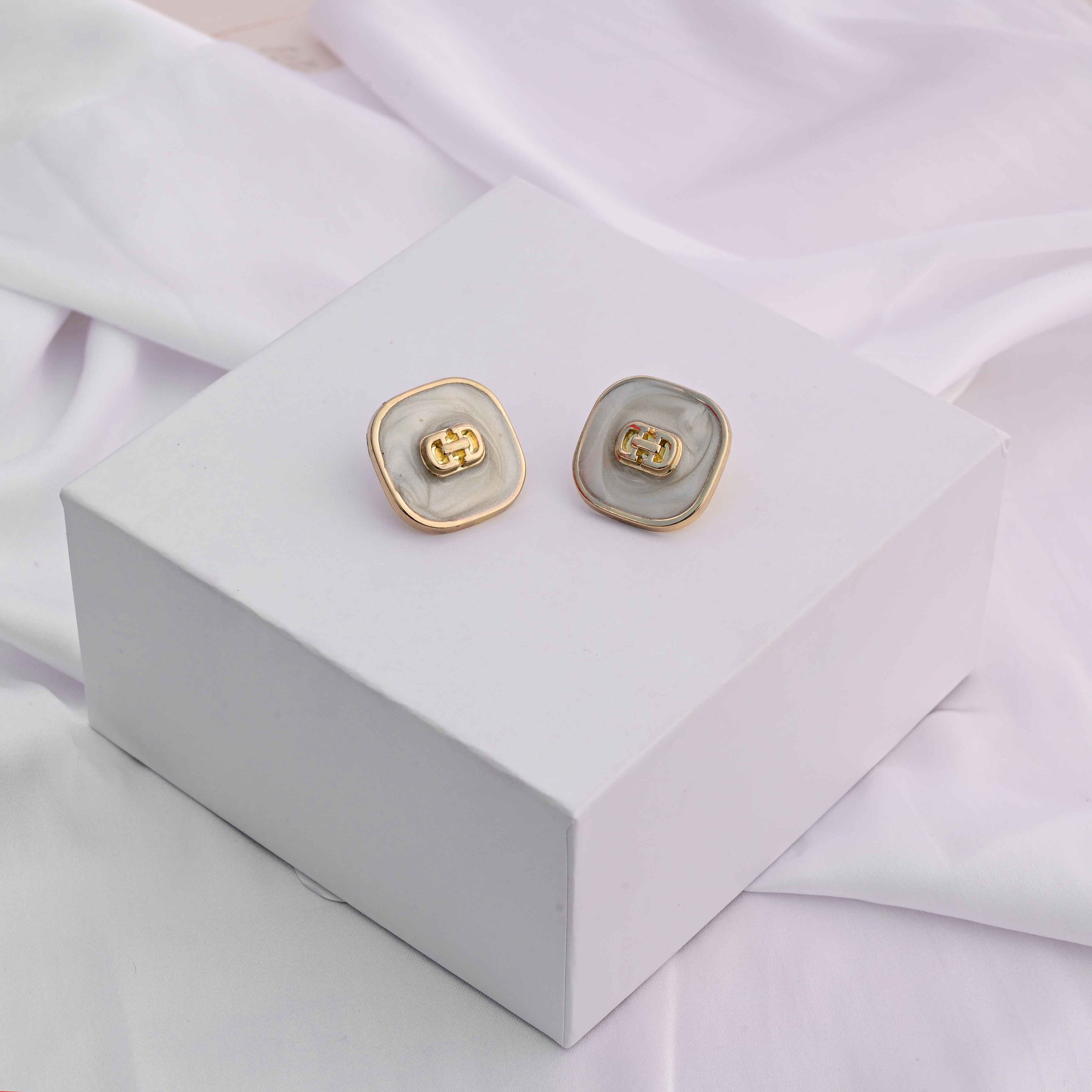 Square gold earrings with ivory enamel