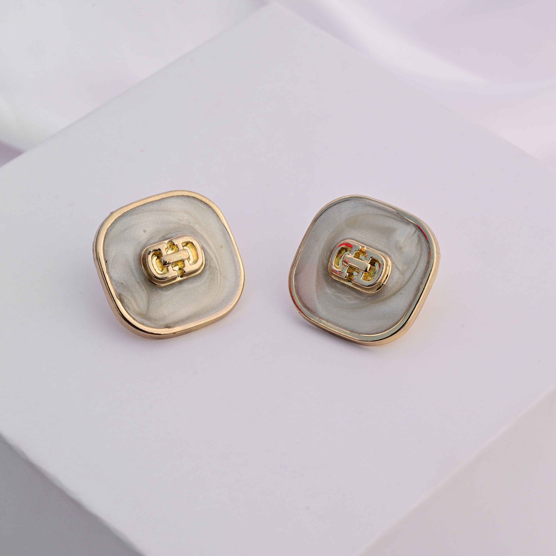 Square gold earrings with ivory enamel