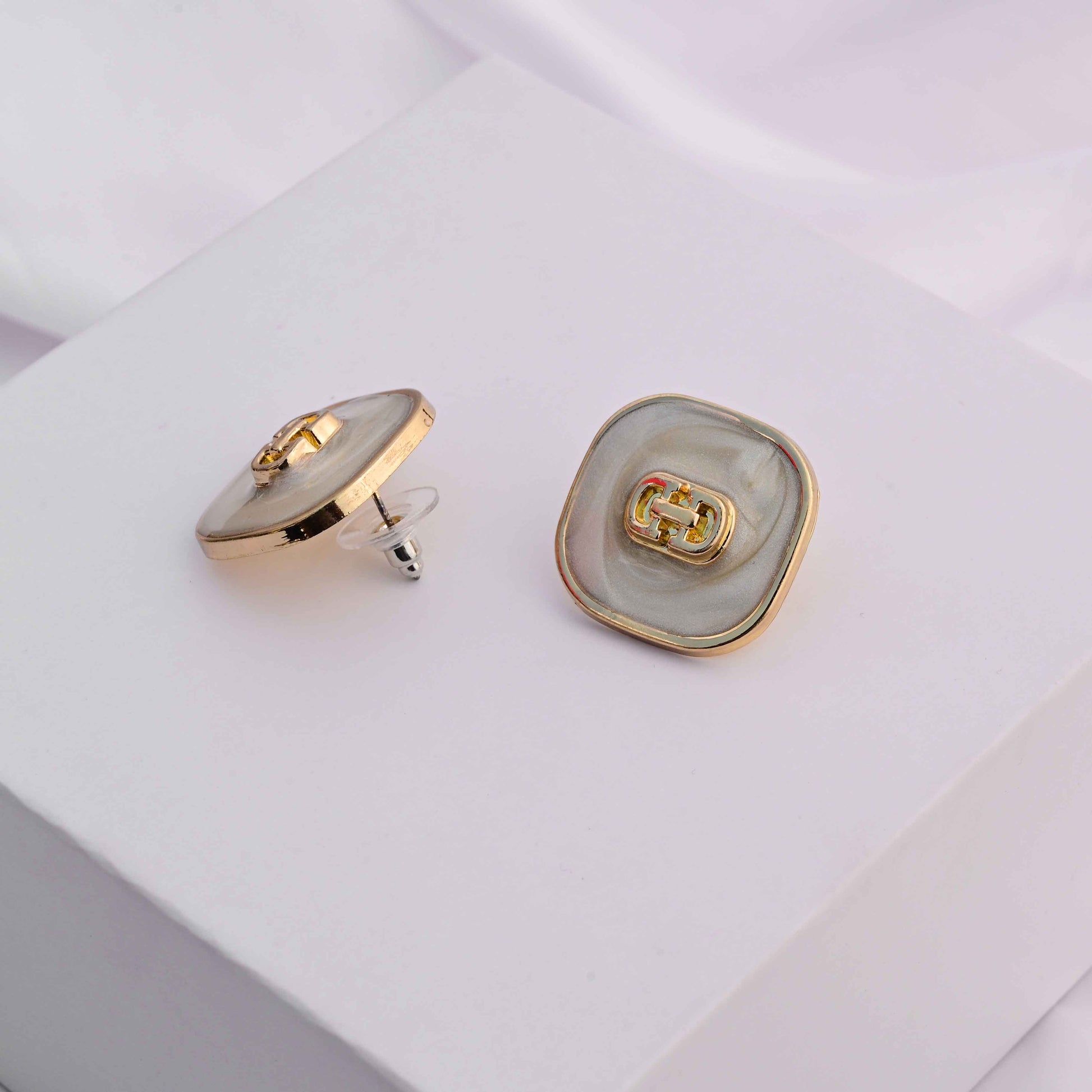 Square gold earrings with ivory enamel