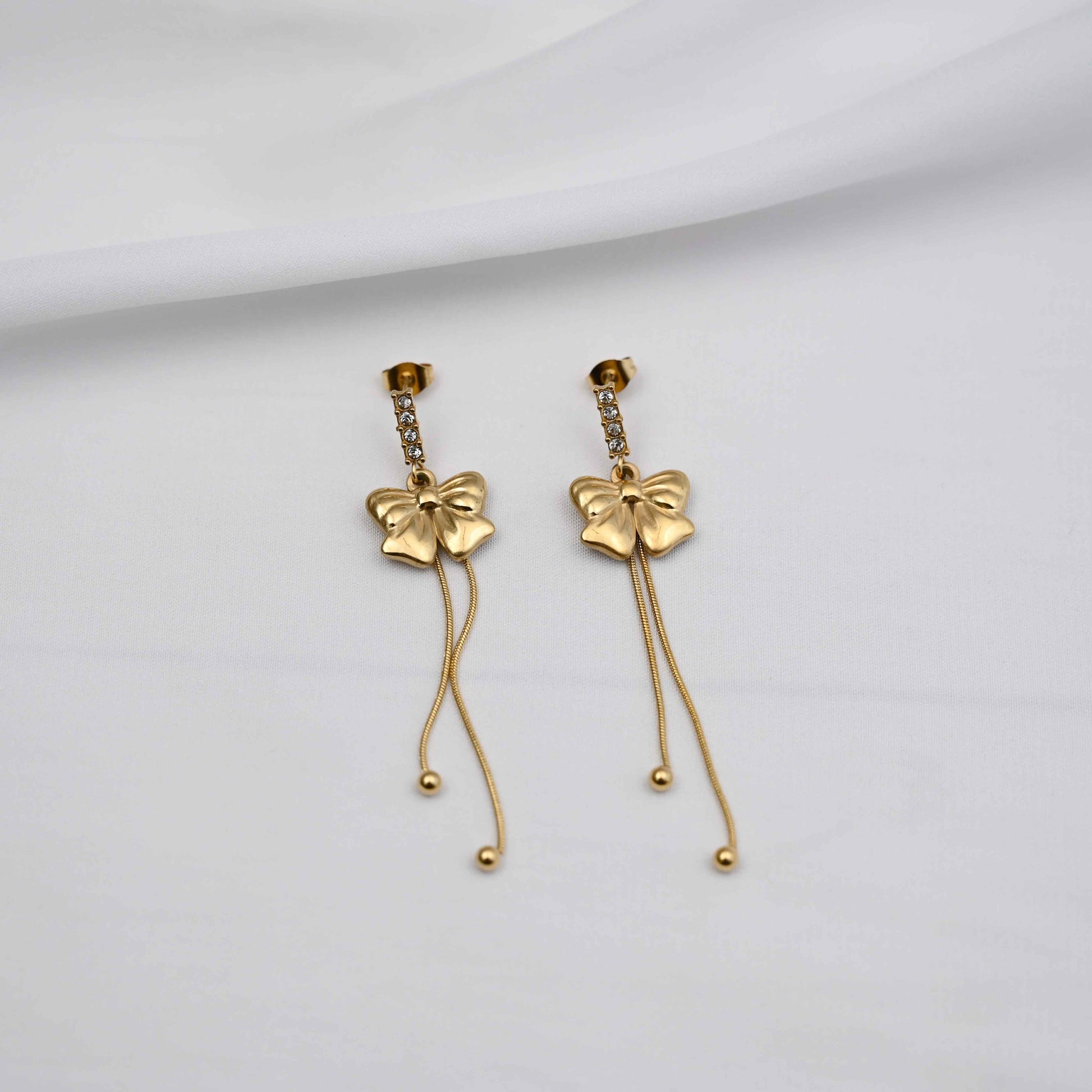 Dangling bows earrings in gold