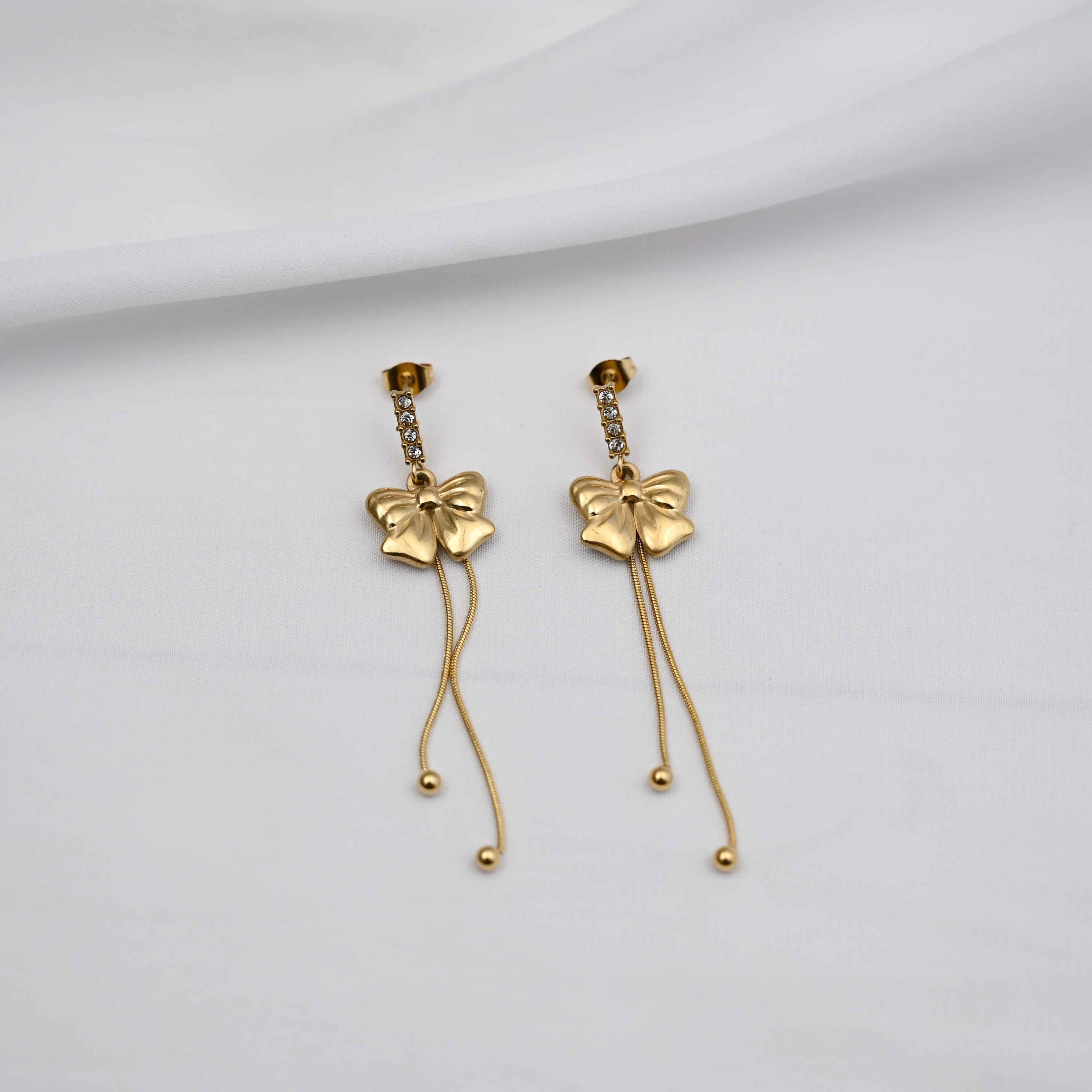 Dangling bows earrings in gold