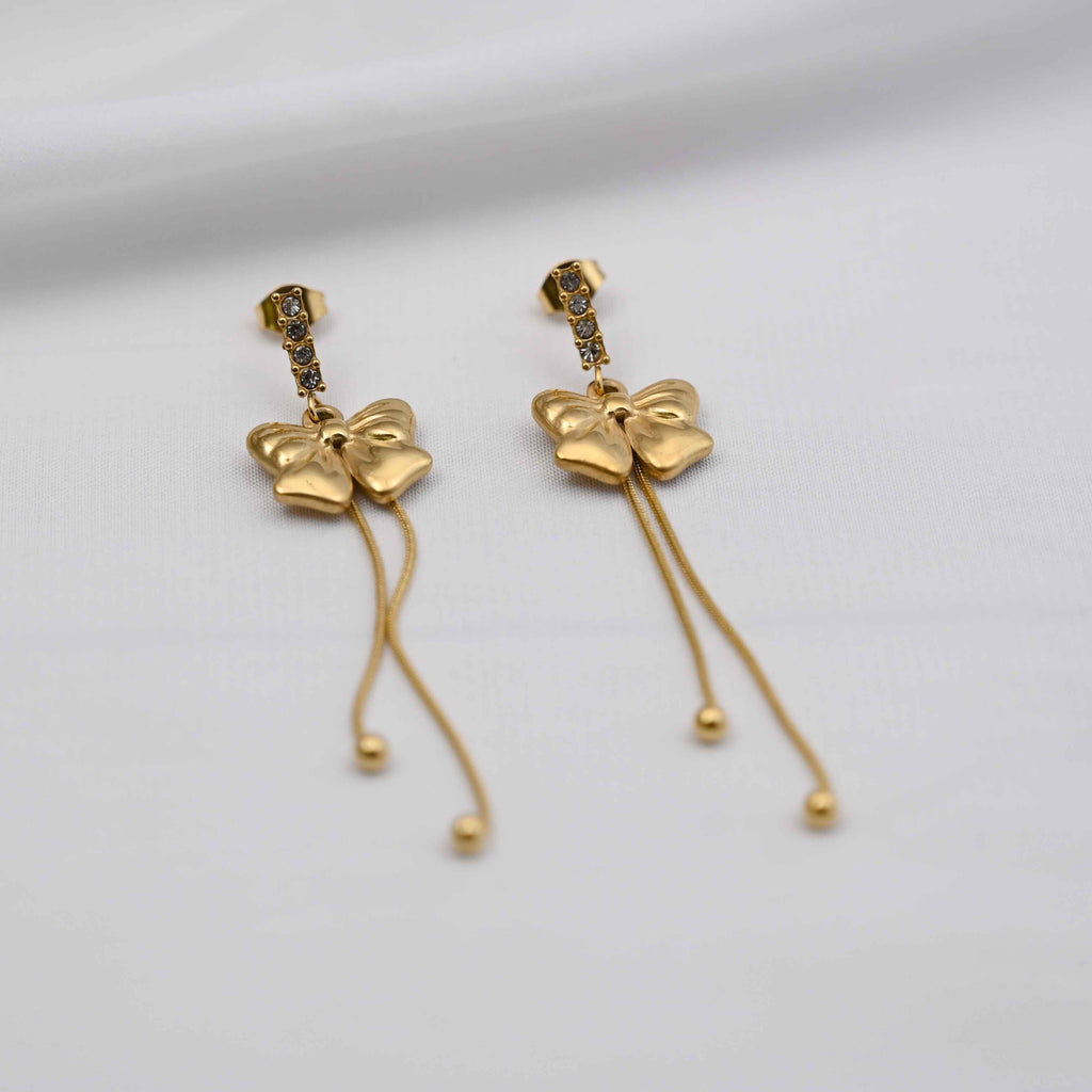 Dangling bows earrings in gold