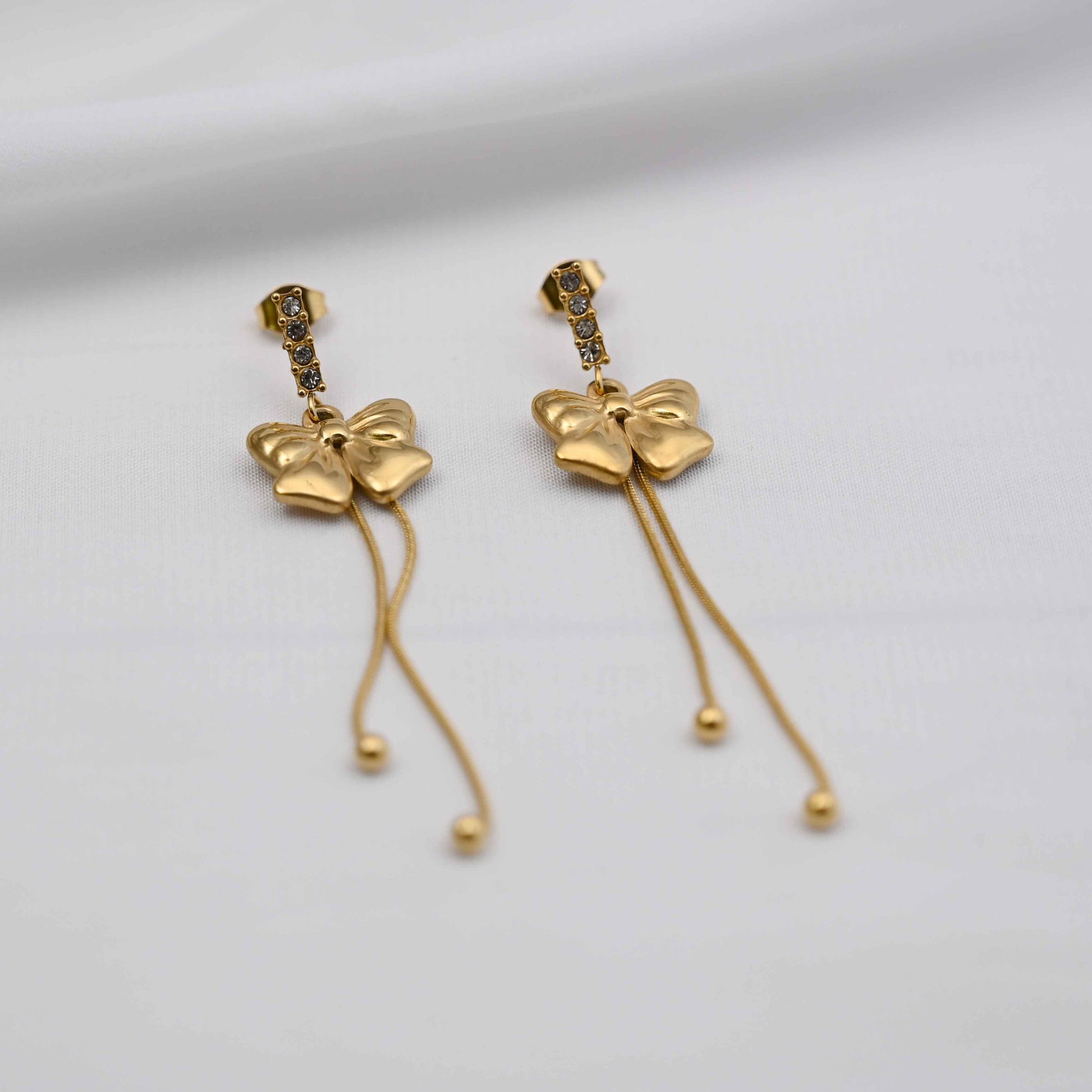 Dangling bows earrings in gold