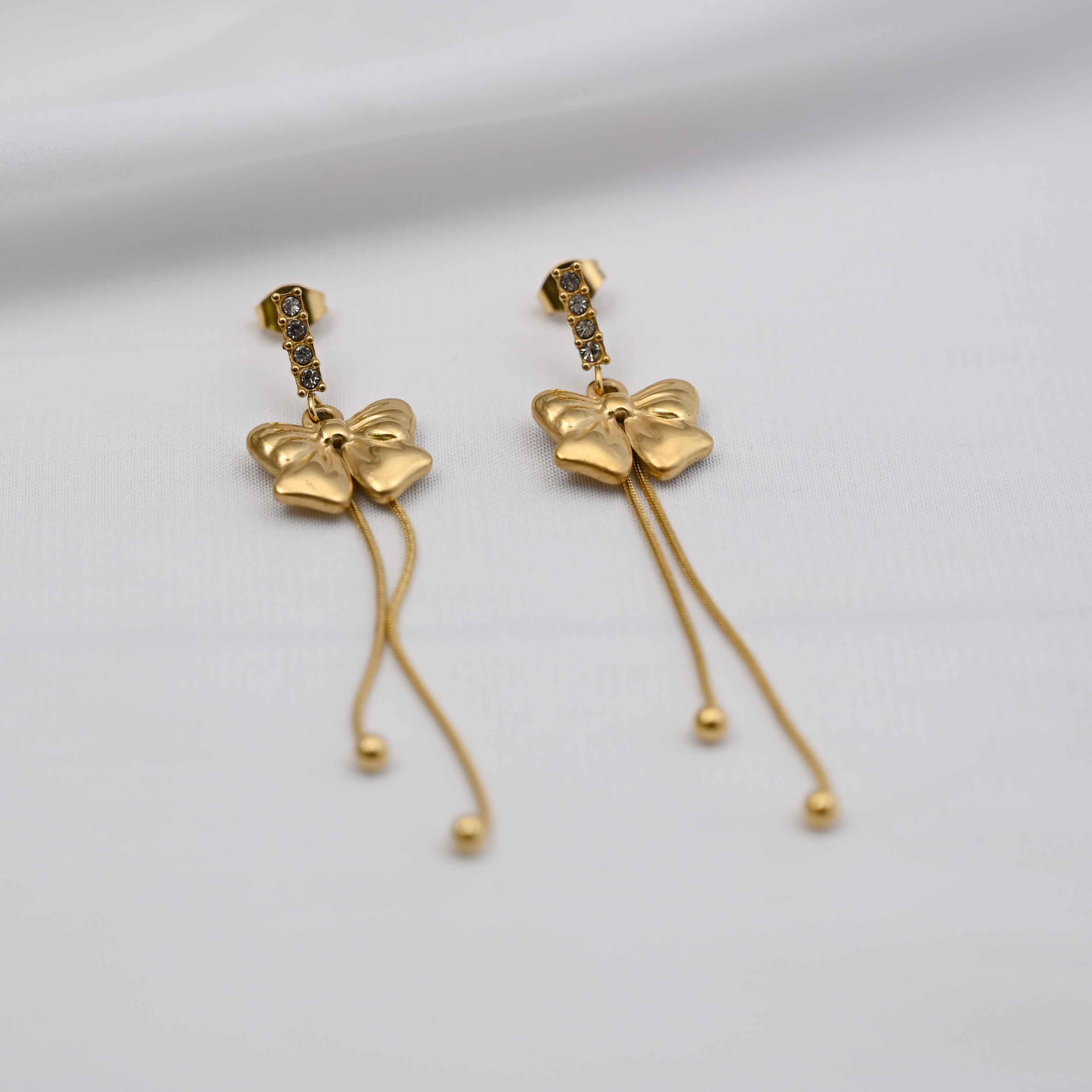 Dangling bows earrings in gold