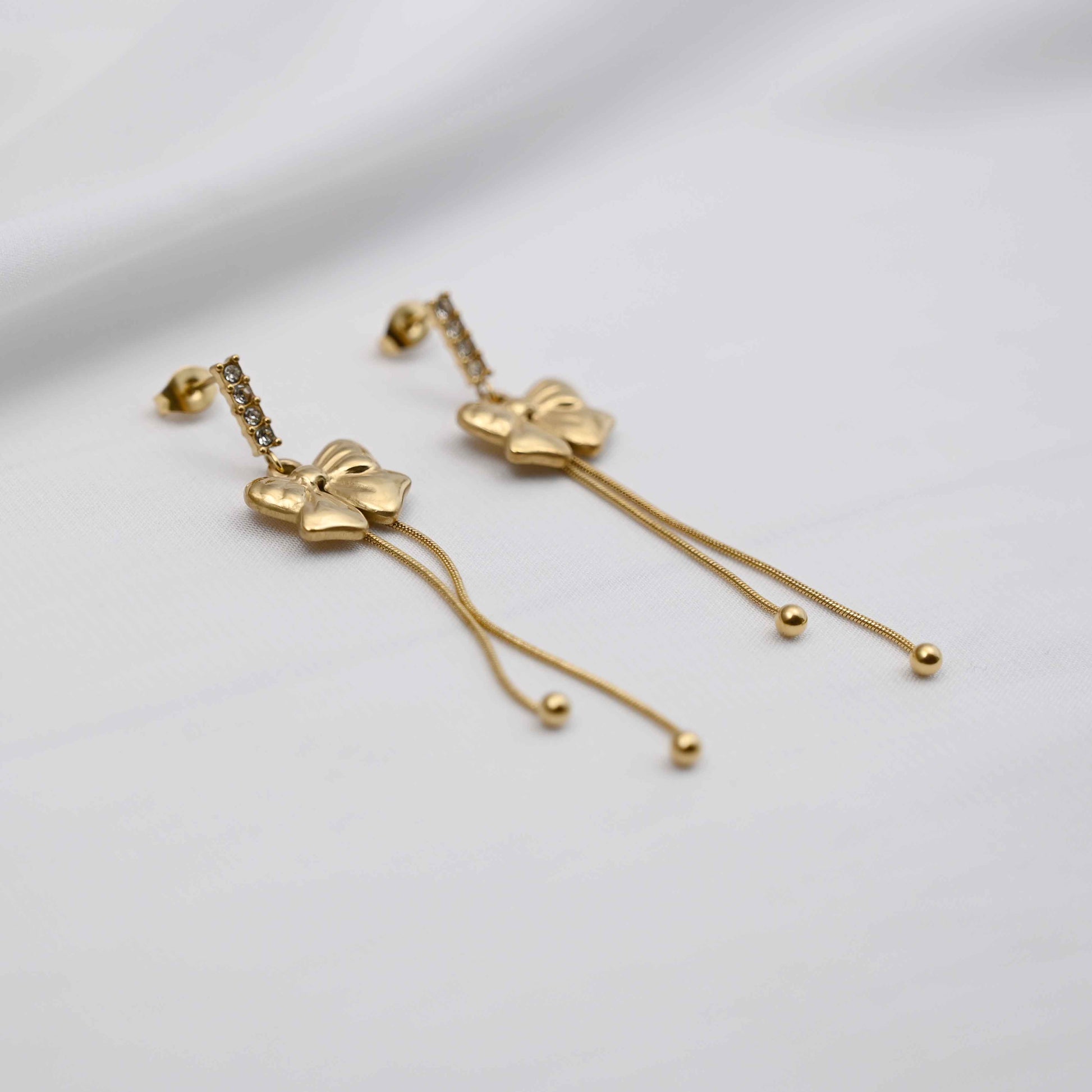 Dangling bows earrings in gold
