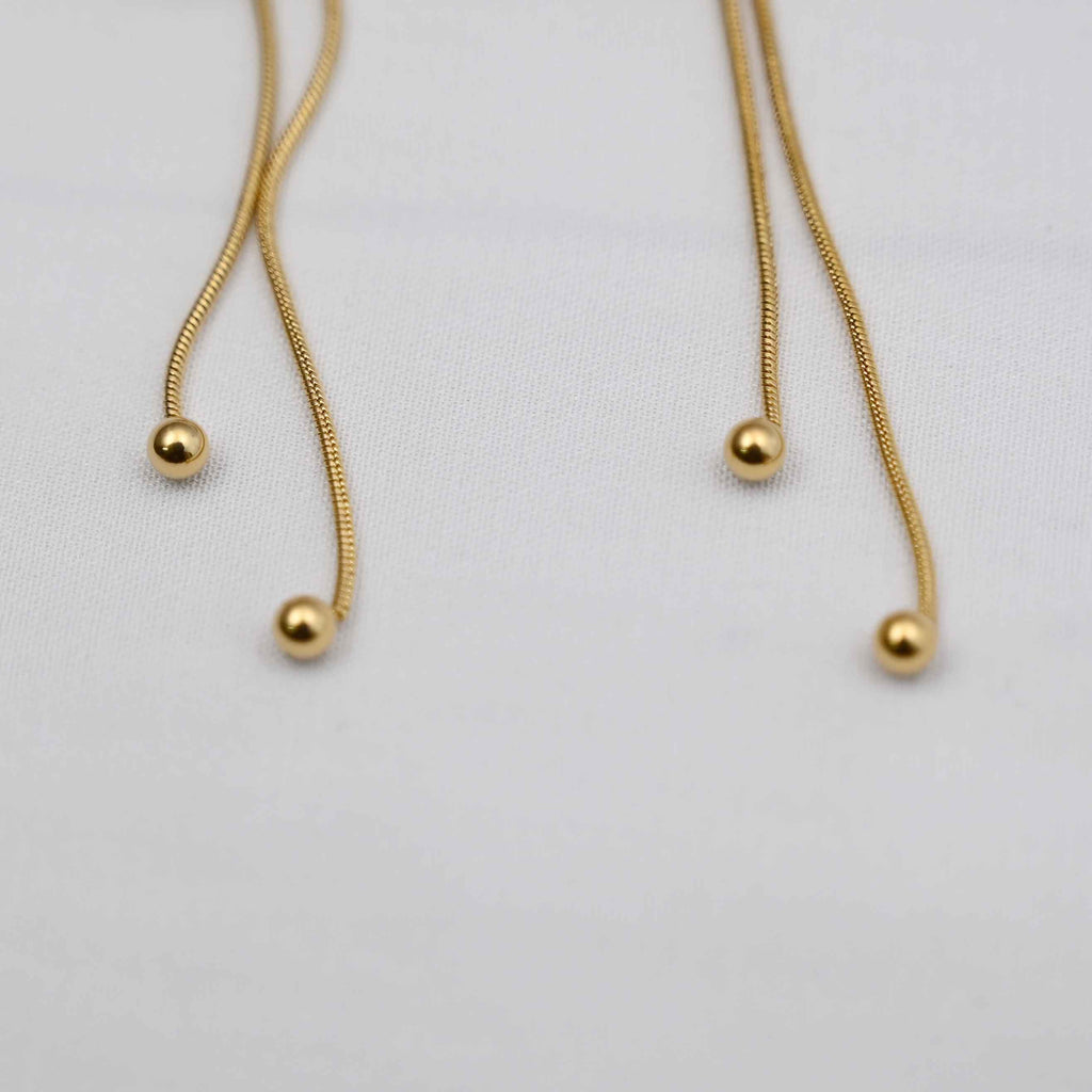 Dangling bows earrings in gold