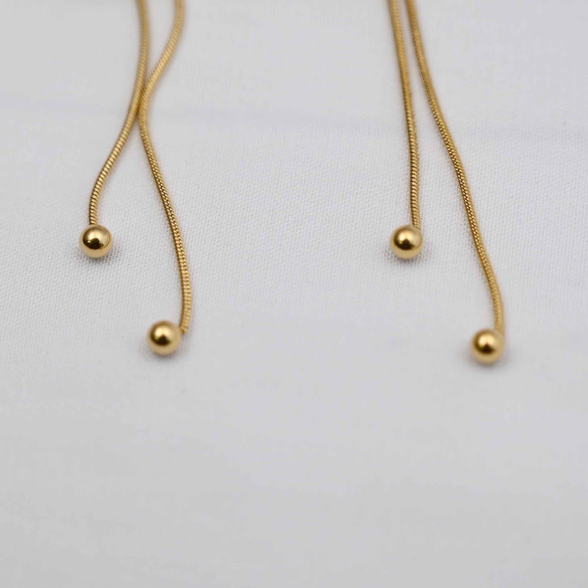 Dangling bows earrings in gold