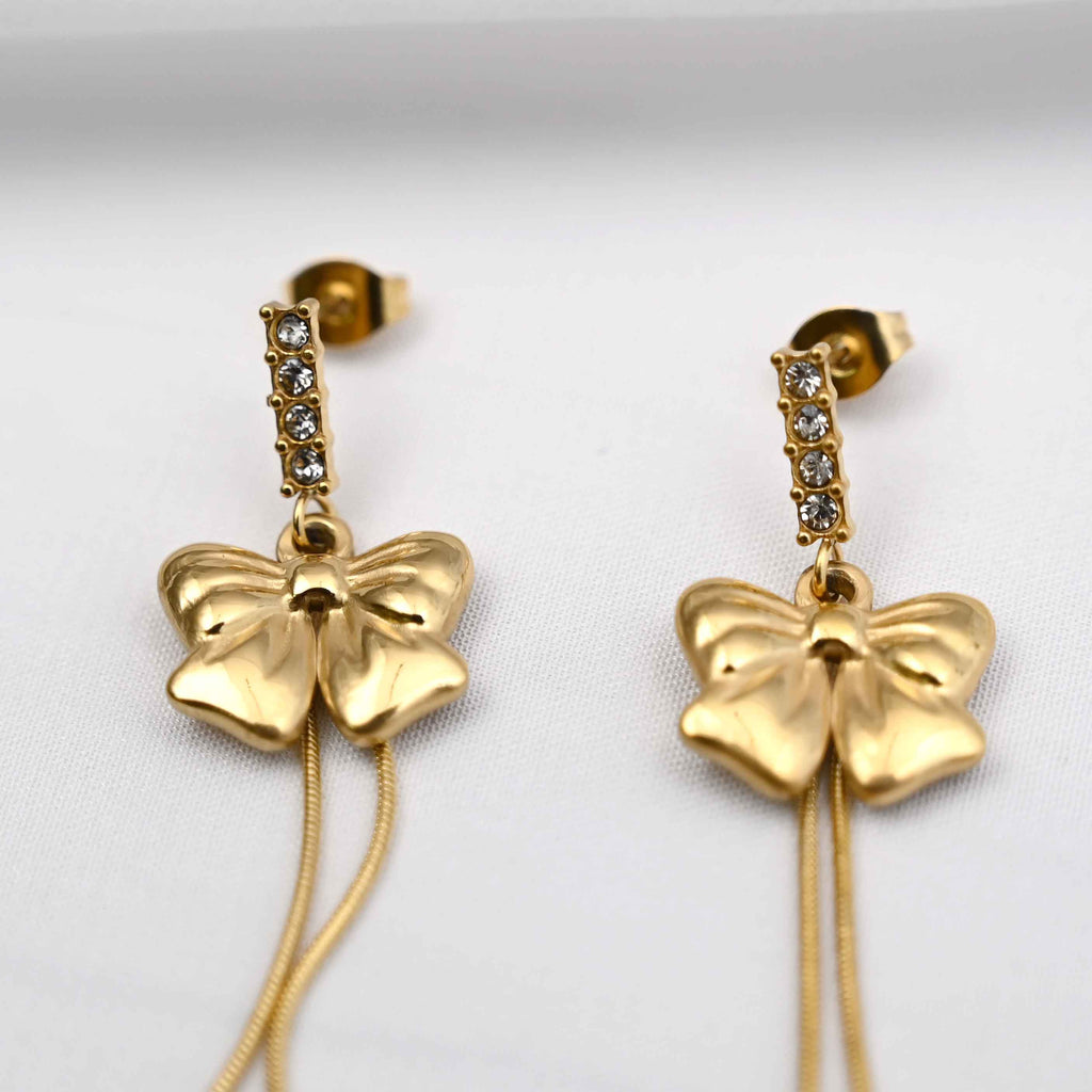 Dangling bows earrings in gold