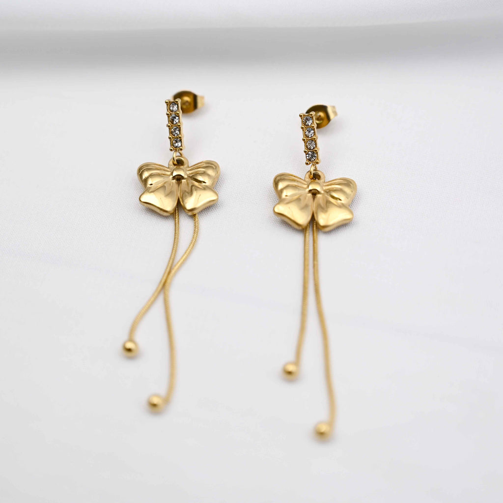 Dangling bows earrings in gold