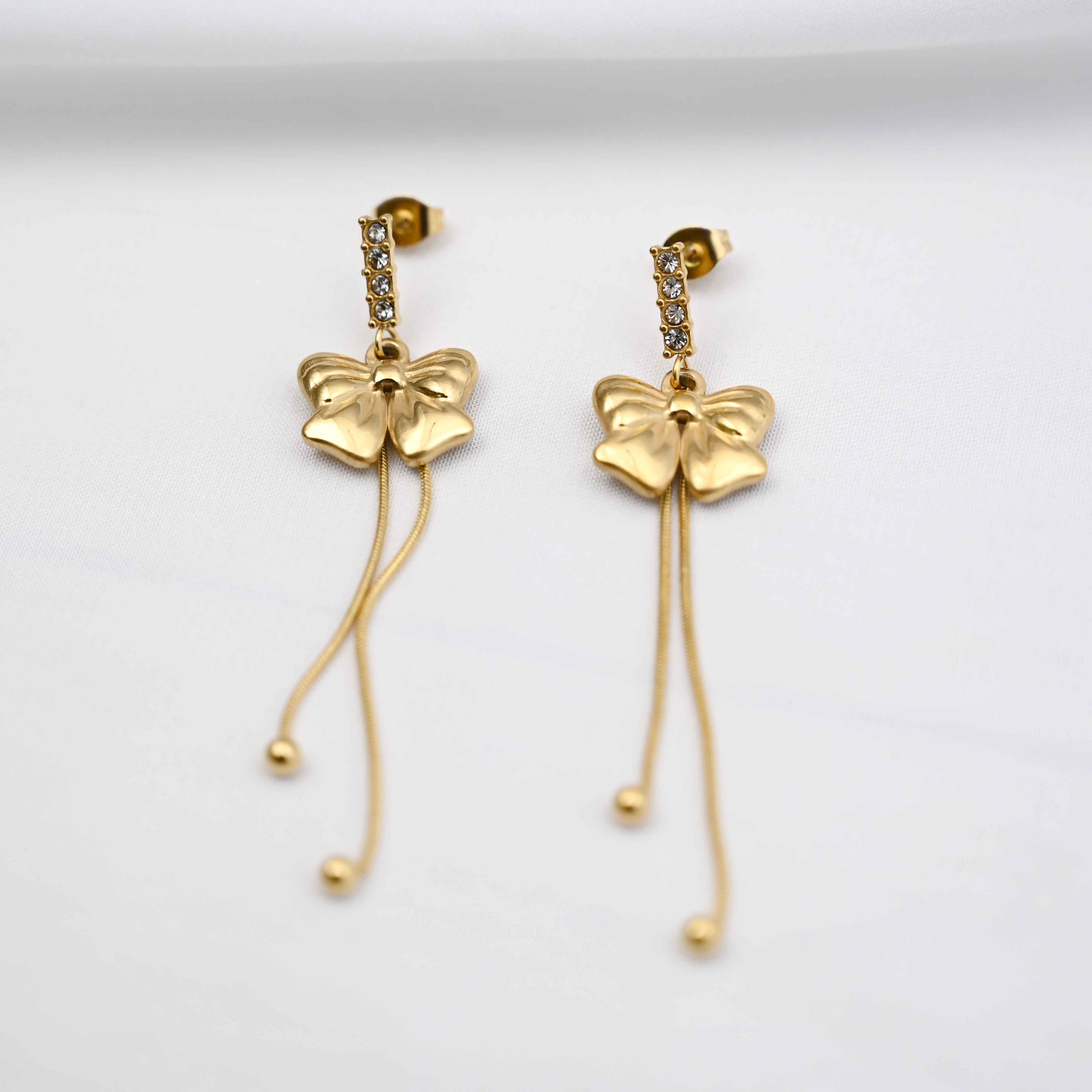 Dangling bows earrings in gold